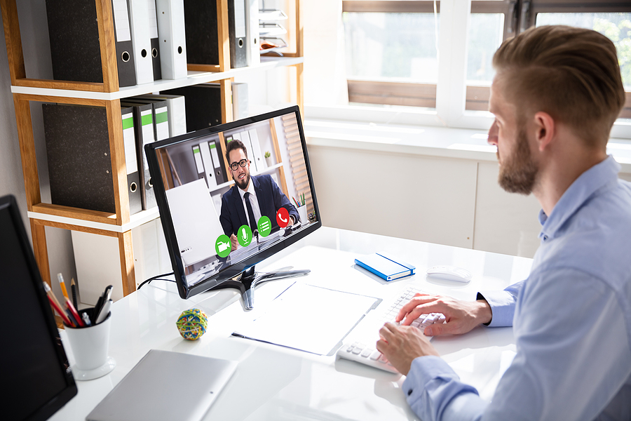 Businessman using video conferencing app in Melbourne with a coworker