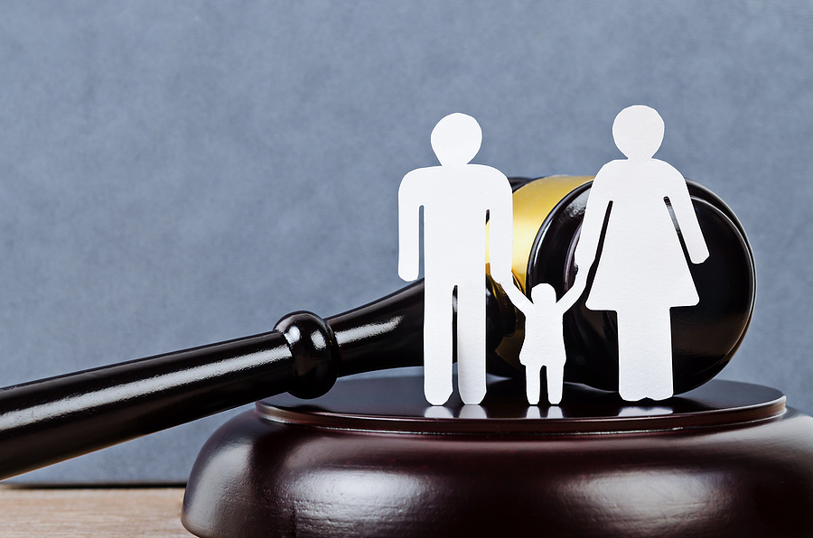 A figure of a family and a gavel. Family law concept
